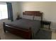 This bedroom features a large bed, wood furniture, and a window with curtains at 6728 Thorman Rd, Port Charlotte, FL 33981