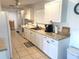 Bright open kitchen featuring white cabinetry, countertops, and modern appliances at 6728 Thorman Rd, Port Charlotte, FL 33981