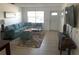 Inviting living room featuring tile flooring, a comfortable sectional, and natural light at 6728 Thorman Rd, Port Charlotte, FL 33981