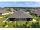 Aerial view of backyard featuring a screened patio surrounded by well-manicured lawn and lush landscaping at 7209 W Lenox Cir, Punta Gorda, FL 33950