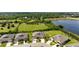 Aerial view of the home showcasing its location within a lush, green community with pond views at 7209 W Lenox Cir, Punta Gorda, FL 33950