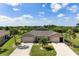 Aerial view of two homes with well-maintained lawns, palm trees, and beautiful landscaping in the community at 7209 W Lenox Cir, Punta Gorda, FL 33950