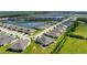 Aerial view of home featuring a serene lake nearby and well-maintained landscaping, within a vibrant community at 7209 W Lenox Cir, Punta Gorda, FL 33950