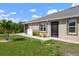 Home showcasing a side view of the backyard and patio area with a garden and access to the main house at 7209 W Lenox Cir, Punta Gorda, FL 33950
