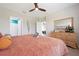 Spacious bedroom with large bed, dresser, and view into other rooms at 7209 W Lenox Cir, Punta Gorda, FL 33950