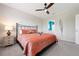 Comfortable bedroom featuring a black metal bed frame and a ceiling fan with light at 7209 W Lenox Cir, Punta Gorda, FL 33950