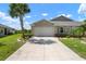 Charming single-Gathering home featuring a two-car garage, lush landscaping, and a well-maintained lawn at 7209 W Lenox Cir, Punta Gorda, FL 33950