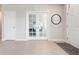 Bright foyer with tile flooring, features a study with glass doors and neutral paint at 7209 W Lenox Cir, Punta Gorda, FL 33950