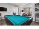 Bright game room featuring a billiard table, TV, and views into a dining area with seating at 7209 W Lenox Cir, Punta Gorda, FL 33950