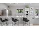 Modern kitchen featuring sleek countertops, stainless steel appliances, and a breakfast bar with seating at 7209 W Lenox Cir, Punta Gorda, FL 33950