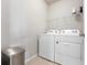 Functional laundry room with a washing machine, dryer, and storage shelf at 7209 W Lenox Cir, Punta Gorda, FL 33950