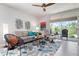Bright living room with stylish furniture, decorative accents, and sliding glass doors to the outdoor area at 7209 W Lenox Cir, Punta Gorda, FL 33950
