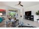 Cozy living room with comfortable seating, a large TV, and a view of the outdoors at 7209 W Lenox Cir, Punta Gorda, FL 33950