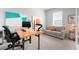 Bright office with modern decor, comfy sofa, and sleek desk setup at 7209 W Lenox Cir, Punta Gorda, FL 33950