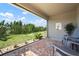 Covered patio with seating area overlooking landscaped backyard and blue sky at 7209 W Lenox Cir, Punta Gorda, FL 33950
