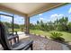 Screened patio with comfortable seating and a view of the green backyard at 7209 W Lenox Cir, Punta Gorda, FL 33950