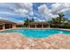 Community pool surrounded by lush landscaping and comfortable seating areas, perfect for relaxation at 7209 W Lenox Cir, Punta Gorda, FL 33950