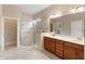 Spacious bathroom with tiled walk-in shower, dual vanity sinks, and ample lighting at 8725 Amaretto Ave, Sarasota, FL 34238
