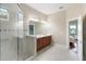 Serene bathroom with tiled walk-in shower, dual sinks, and large vanity mirror at 8725 Amaretto Ave, Sarasota, FL 34238