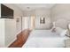 Comfortable bedroom with hardwood floors, neutral walls, and ensuite bathroom access at 8725 Amaretto Ave, Sarasota, FL 34238