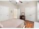 This bedroom offers neutral walls, ceiling fan, hard wood floors, and multiple closets at 8725 Amaretto Ave, Sarasota, FL 34238