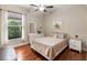 This bedroom offers natural light, hard wood floors, and calming decor at 8725 Amaretto Ave, Sarasota, FL 34238