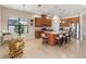 Well-equipped kitchen with granite countertops, stainless steel appliances, and a large center island with breakfast bar seating at 8725 Amaretto Ave, Sarasota, FL 34238