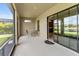 Screened-in lanai with seating and sliding door to the interior at 8725 Amaretto Ave, Sarasota, FL 34238