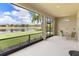 Screened-in lanai with seating and a view of a lake at 8725 Amaretto Ave, Sarasota, FL 34238