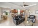 Spacious living room open to the kitchen, with neutral tones, tile flooring, and views of the lanai providing seamless entertaining at 8725 Amaretto Ave, Sarasota, FL 34238