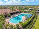 Resort-style community pool with ample seating, cabanas, and lush landscaping, providing a luxurious and relaxing experience at 8725 Amaretto Ave, Sarasota, FL 34238