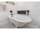 Stylish bathroom featuring a claw foot tub and classic tile at 114 Mcgregor St, Punta Gorda, FL 33950