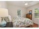Bright bedroom with ceiling fan, natural light, wood floors, and vibrant lemon-themed bed linens at 114 Mcgregor St, Punta Gorda, FL 33950