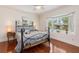 Cozy bedroom with bay window allowing for natural light and hardwood floors at 114 Mcgregor St, Punta Gorda, FL 33950
