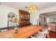 Bright dining area featuring hardwood floors, wooden table with display cabinet, and seamless living transitions at 114 Mcgregor St, Punta Gorda, FL 33950