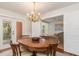 Formal dining room showcasing a wood table, chandelier and hardwood floors, view of living room at 114 Mcgregor St, Punta Gorda, FL 33950