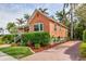Charming single-Gathering home featuring a well-manicured lawn, covered porch, and brick driveway at 114 Mcgregor St, Punta Gorda, FL 33950