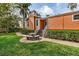 Beautiful home featuring a brick walkway, stone seating area, and a charming facade with a welcoming entrance at 114 Mcgregor St, Punta Gorda, FL 33950