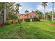Charming home featuring a lush green lawn, vibrant tropical landscaping, and a cozy exterior at 114 Mcgregor St, Punta Gorda, FL 33950