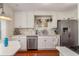 Bright kitchen featuring white cabinets, stainless steel appliances, marble backsplash and hardwood floors at 114 Mcgregor St, Punta Gorda, FL 33950