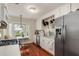 Bright kitchen featuring stainless steel appliances, white cabinets, and a cozy breakfast nook at 114 Mcgregor St, Punta Gorda, FL 33950