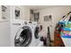 Convenient laundry area equipped with modern washer and dryer units and essential cleaning supplies at 114 Mcgregor St, Punta Gorda, FL 33950