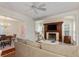 Bright living room features a fireplace, ceiling fan, and adjacent dining area for easy entertaining at 114 Mcgregor St, Punta Gorda, FL 33950