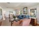 Bright living room featuring hardwood floors, natural light, and seamless transition to other living spaces at 114 Mcgregor St, Punta Gorda, FL 33950