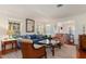 Inviting living room filled with natural light, showcasing hardwood floors and a seamless flow to the dining area at 114 Mcgregor St, Punta Gorda, FL 33950