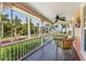 Relaxing porch with outdoor seating, ideal for enjoying the scenic views of palm trees and water at 114 Mcgregor St, Punta Gorda, FL 33950