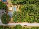 Aerial view showing the home's layout, including the pool, patio, and surrounding greenery, within property lines at 1173 Belmar Ave, Port Charlotte, FL 33948