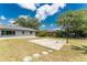 An ample backyard with a basketball court and partial view of the house at 1173 Belmar Ave, Port Charlotte, FL 33948
