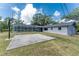 Wide backyard view with basketball court and screened in pool area at 1173 Belmar Ave, Port Charlotte, FL 33948