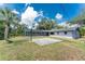 Wide backyard view with basketball court and screened in pool area at 1173 Belmar Ave, Port Charlotte, FL 33948